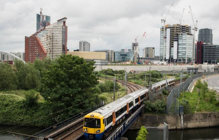 A photo of London's skyline with a train on tracks