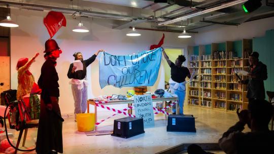 A community performance in a library campaigning for clean air