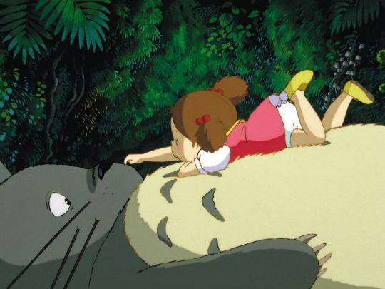 A still frame from a cartoon featuring a small girl wearing a red and white dress lying on top of an overgrown cat